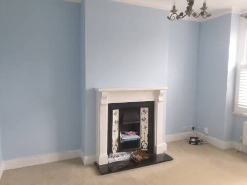Freshly painted living room with a restored fireplace by HandyMack in Kingston upon Thames